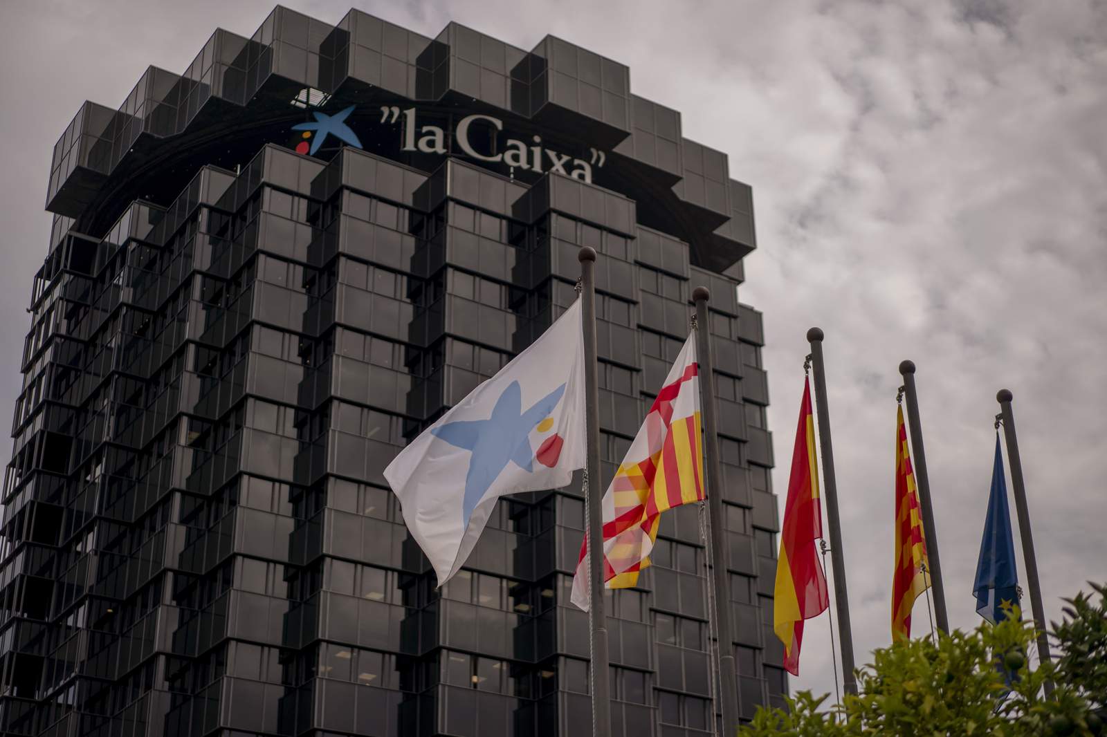 2 Spanish banks merge amid tough times for financial sector