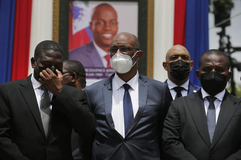 Haiti prosecutor seeks to charge PM in killing, is replaced
