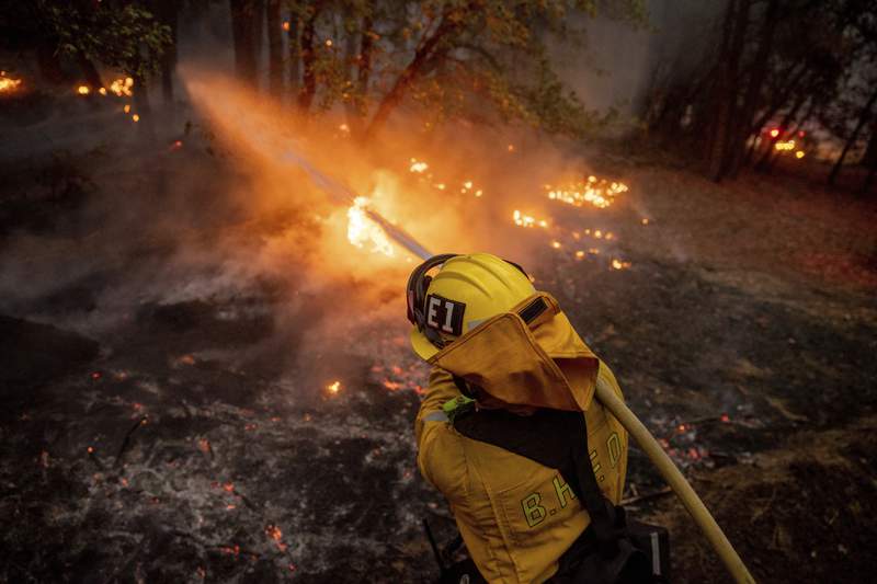 California firefighters battle a dozen large wildfires