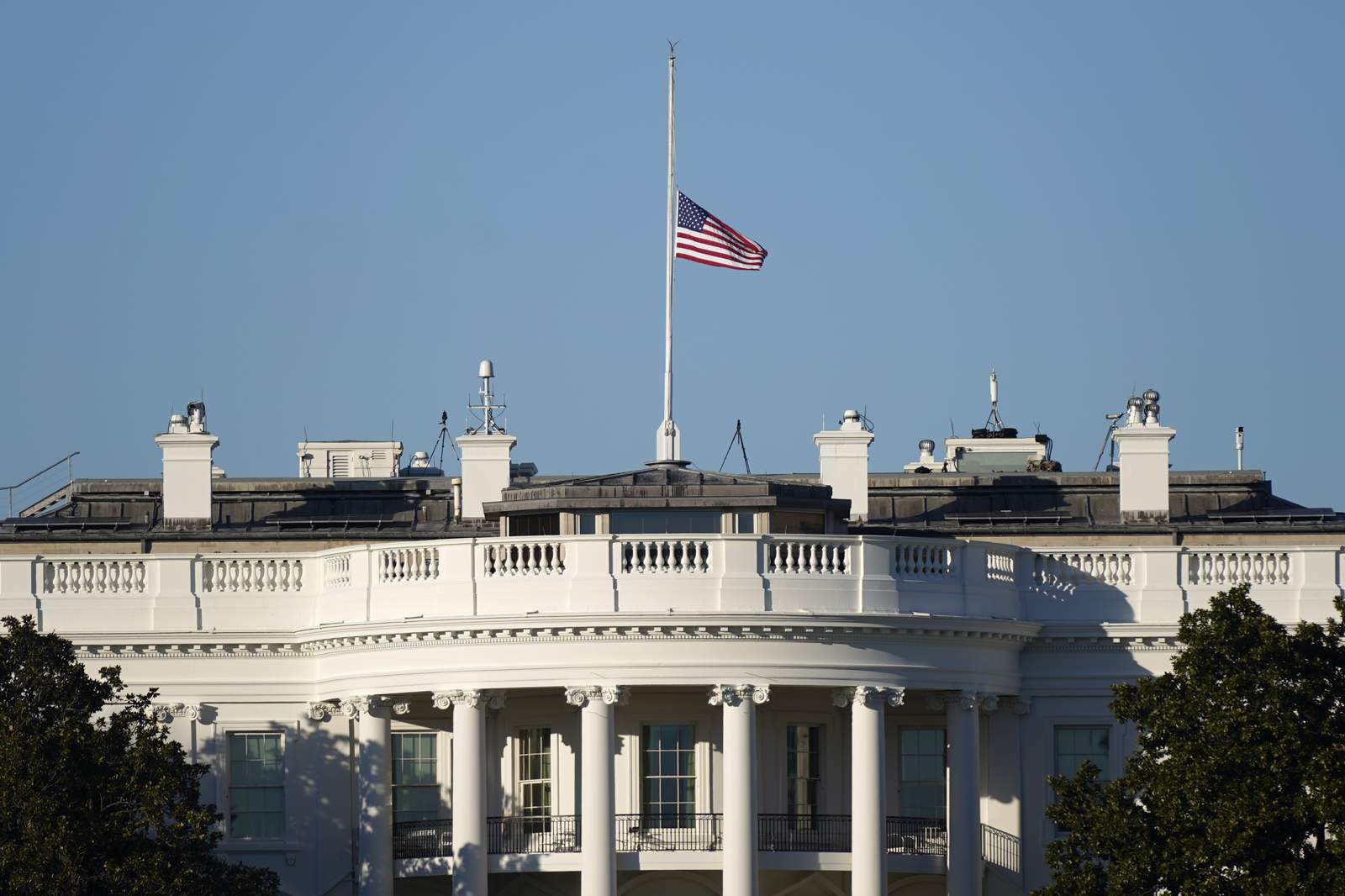 The Latest: Trump orders US flags lowered to honor officers