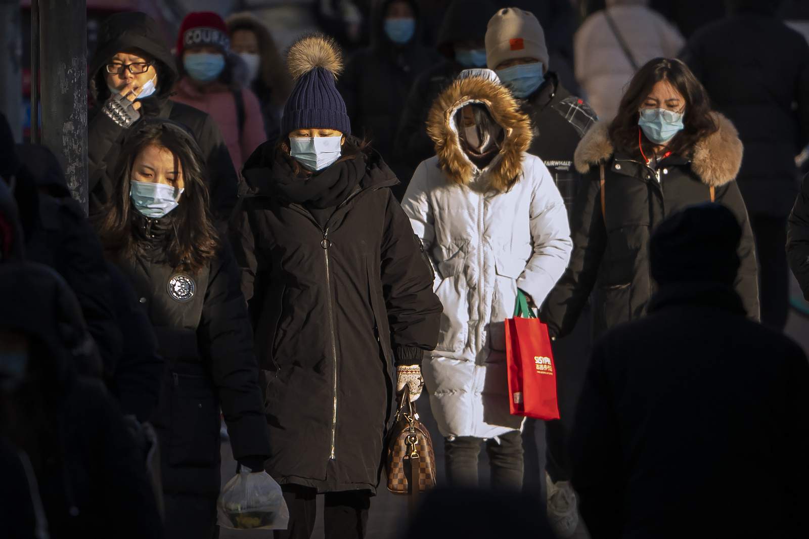 Amid virus fears, China urges workers to skip holiday travel
