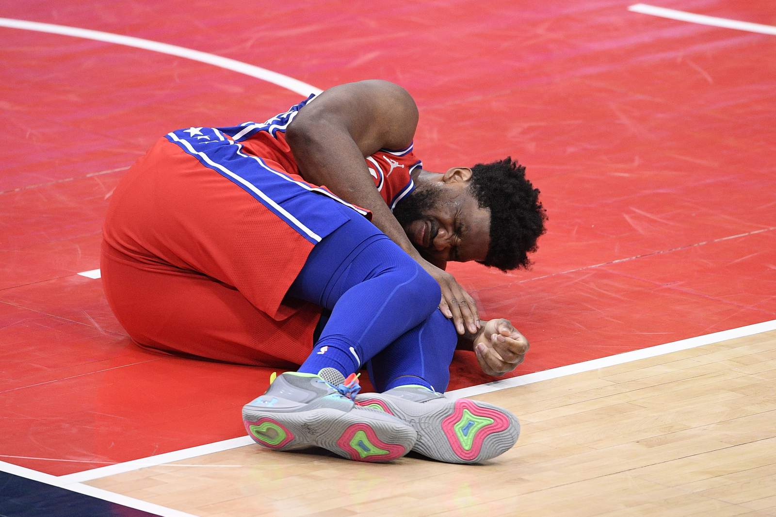 AP source: Embiid could miss up to 2 weeks with knee injury